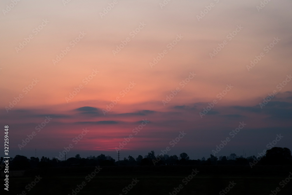 Pink sunset, cloudy sky with a beautiful orange and pink light