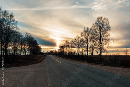 Suburban road goes into the distance at sunset