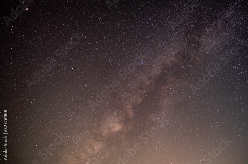 The stars and the milky way in the dark sky at night are very beautiful.