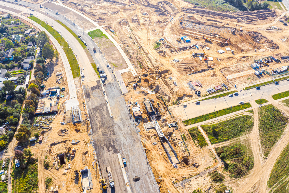aerial top down view on city construction site. building of new asphalt road in residential district aerial top down view on city construction site. building of new asphalt road in residential district