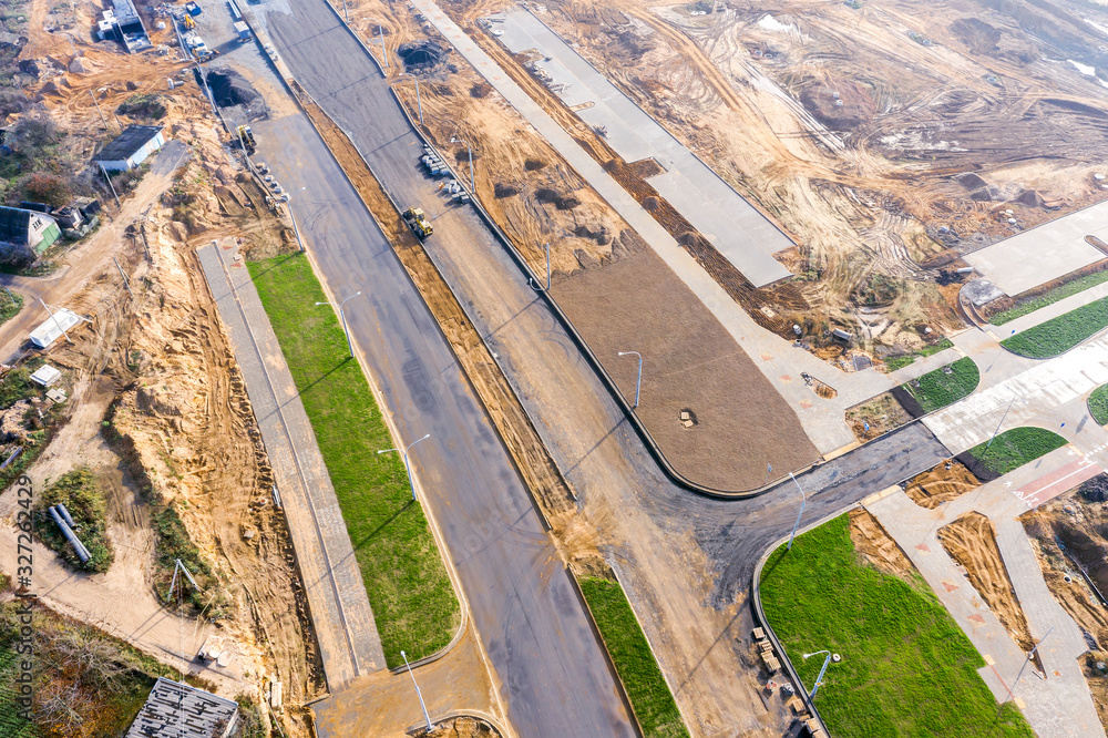 Obraz premium construction of road intersection at new residential district. top view aerial photo from flying drone