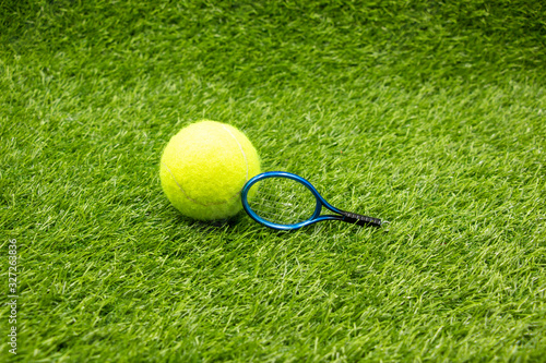 Tennis with racket on green grass