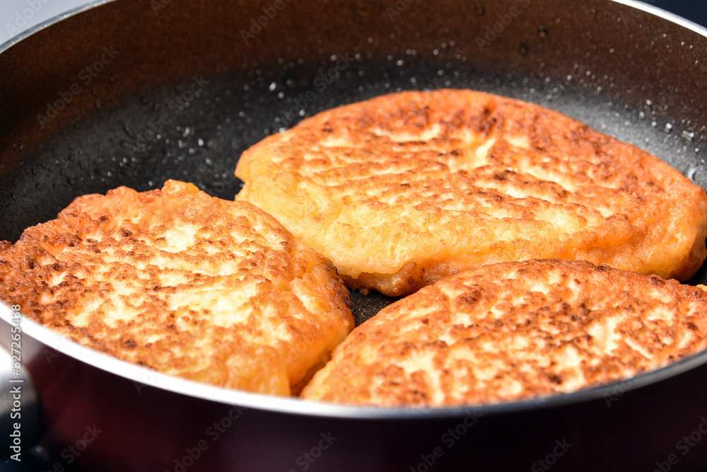 Fritters in a frying pan Fritters in a frying pan