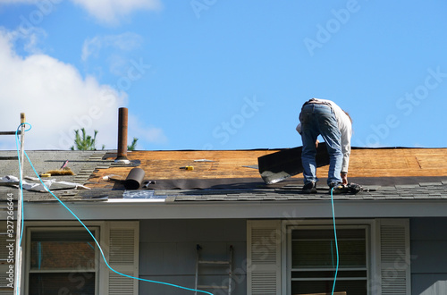 Wallpaper Mural worker install new shingle on the roof of the house for roof repair Torontodigital.ca