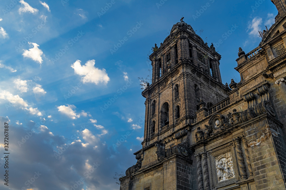 Facade and tower of the Metropolitan Cathedral of Mexico City with a sunbeam illuminating the facade, Mexico.