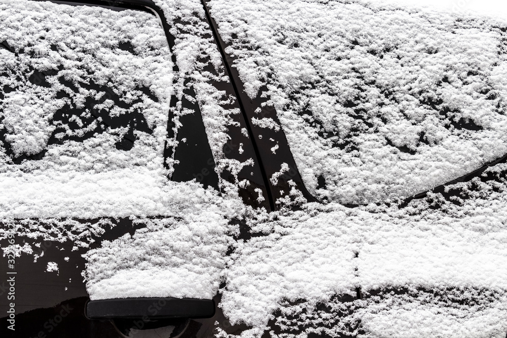 Fototapeta premium The car was completely covered with snow in the backyard.