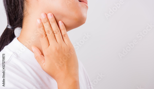 Asian beautiful woman Sore Throat or thyroid gland problem her useing Hand Touching Ill Neck