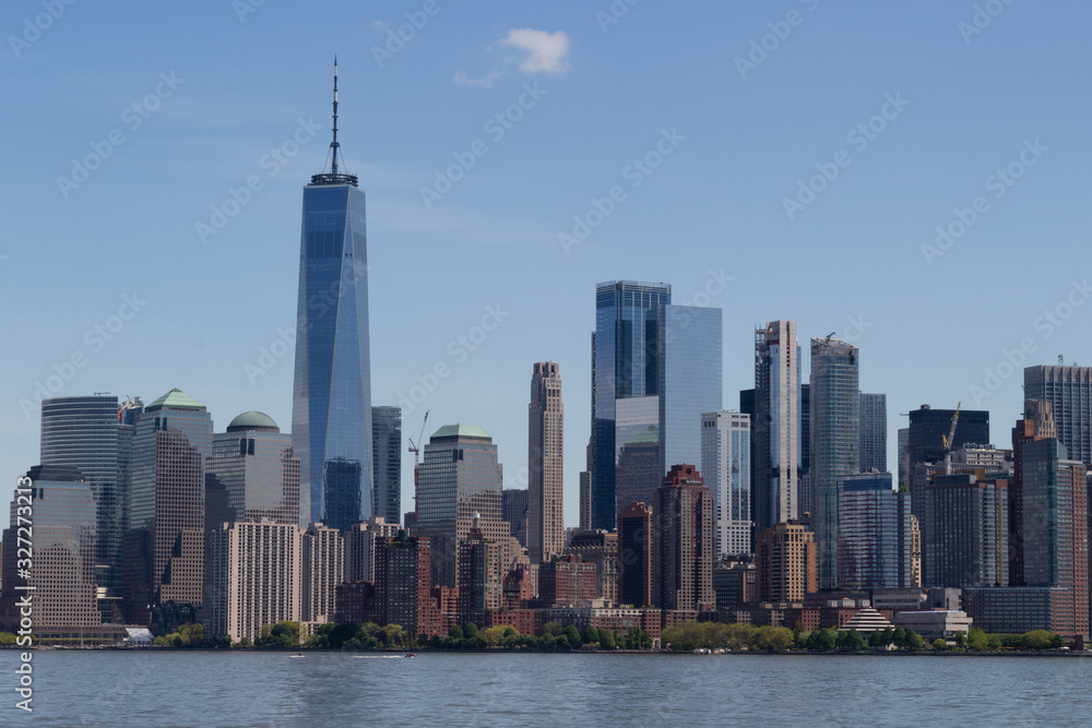 New York City Manhattan downtown skyline with boat over Hudson River panorama