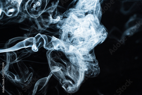 Photo of a wisp of smoke on a dark background