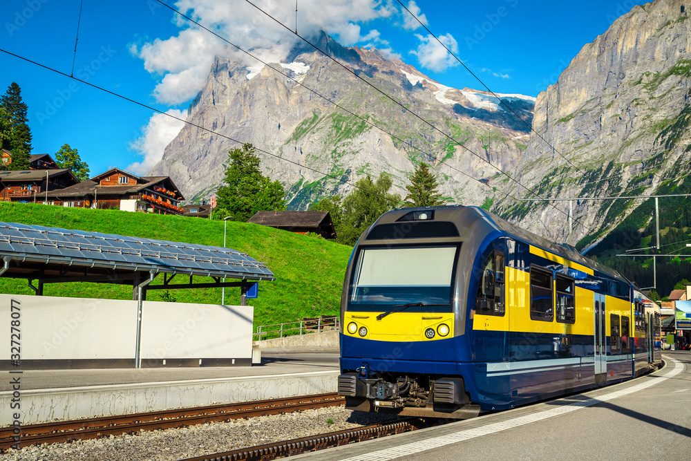 Mountain train station with modern passenger train, Grindelwald, Switzerland