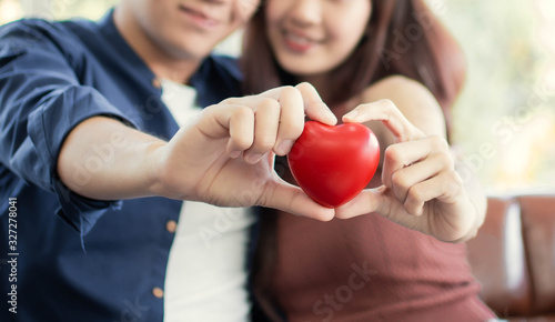 Selective focus on hand holding red heart