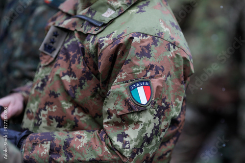 Details with the uniform and the flag on it of an Italian soldier taking part at the Romanian National Day military parade. photo