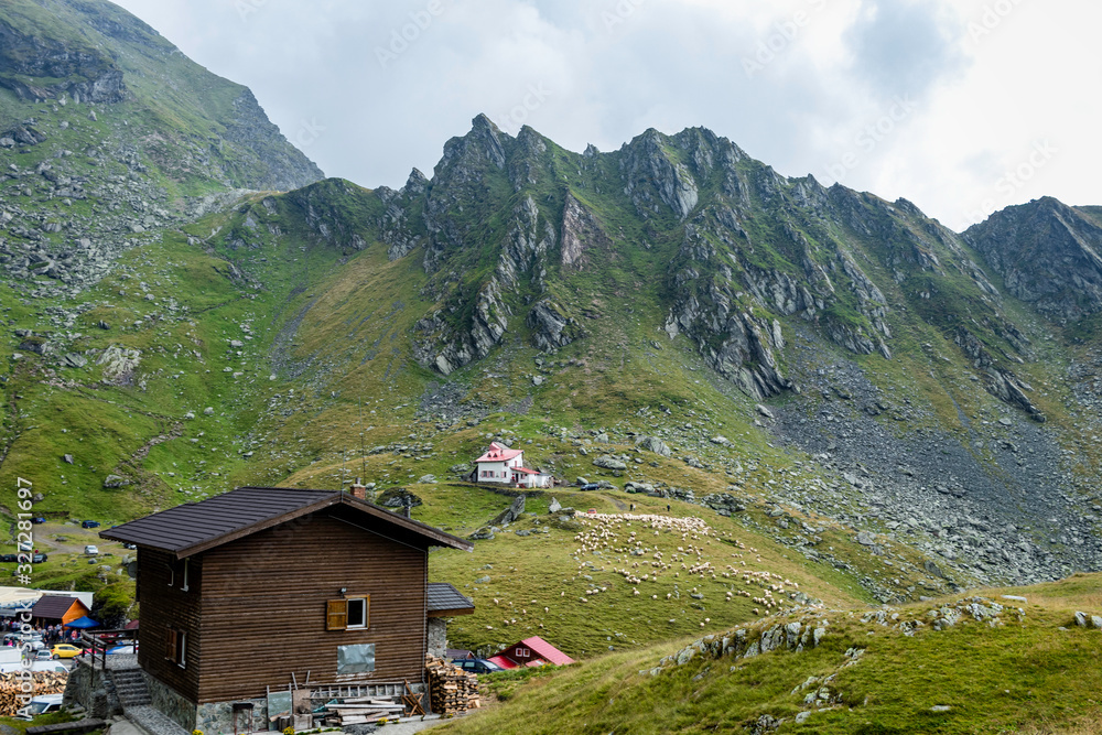 Mountain chalet in the foreground with mountain and mountain rescue house in the background