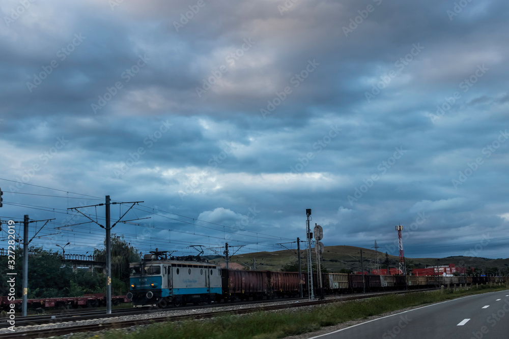 Fototapeta premium Train carrying wheat in an overcast day