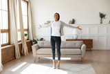 Happy african American woman dancing at home in living room