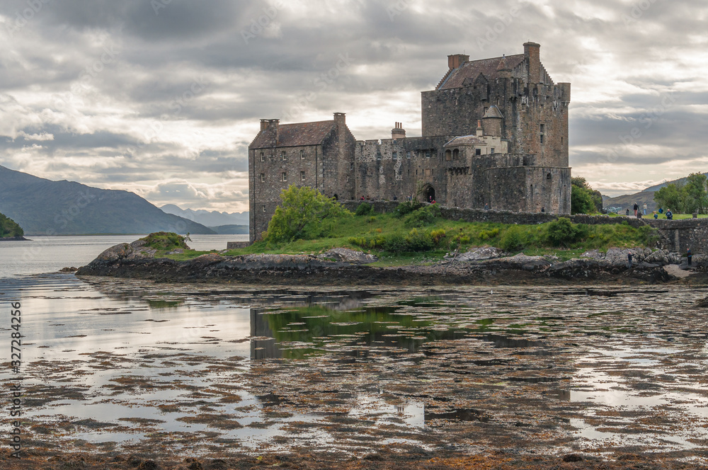 Eilean Donan Castle with its reflection on the waters of Loch Duich, Dornie, Scotland. Concept: fantastic and mythological places, travel to famous places in Scotland
