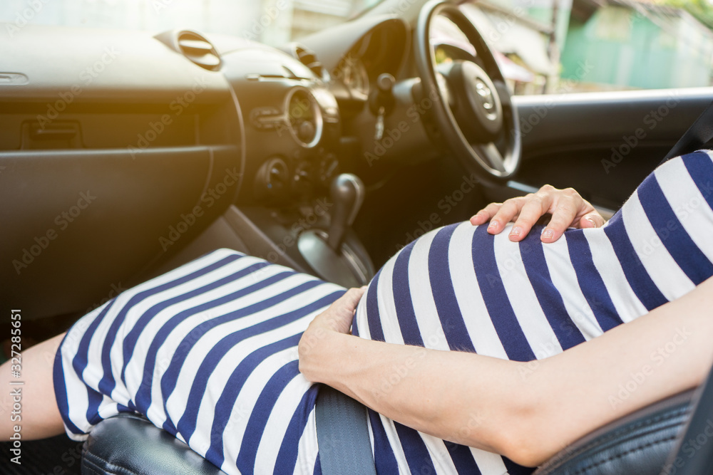 Pregnant woman belly and safety belt in the car. Safe driving when pregnancy.