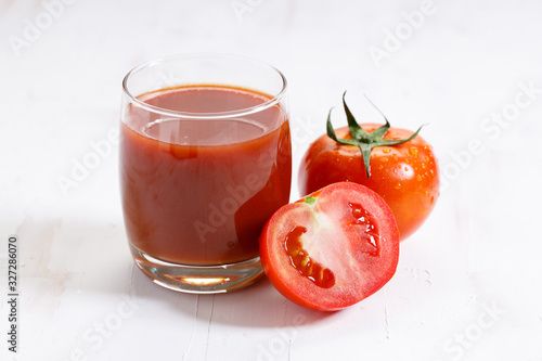 fresh tomatoes on white wooden background