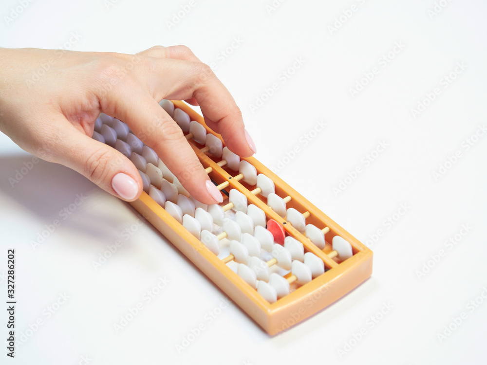 Classes in mental arithmetic, hands and abacus soroban on white background. closeup. copy space Classes in mental arithmetic, hands and abacus soroban on white background. closeup. copy space