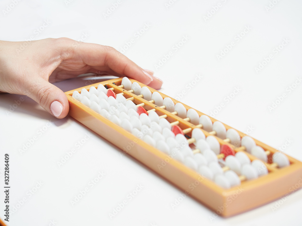 Classes in mental arithmetic, hands and abacus soroban on white background. closeup. copy space Classes in mental arithmetic, hands and abacus soroban on white background. closeup. copy space