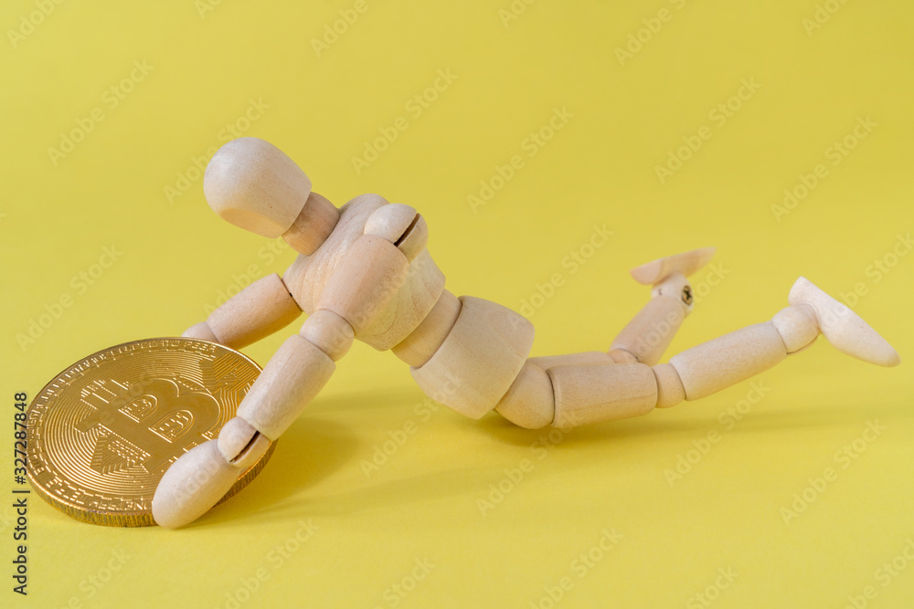 Man tightly holding Bitcoin while falling down Man tightly holding Bitcoin while falling down