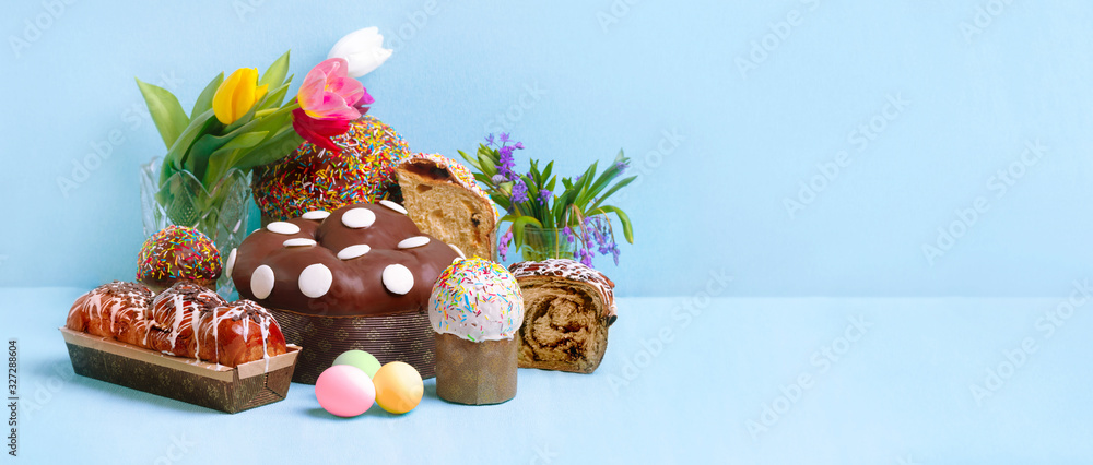 easter cakes, easter bread and eggs over blue background, panoramic mockup