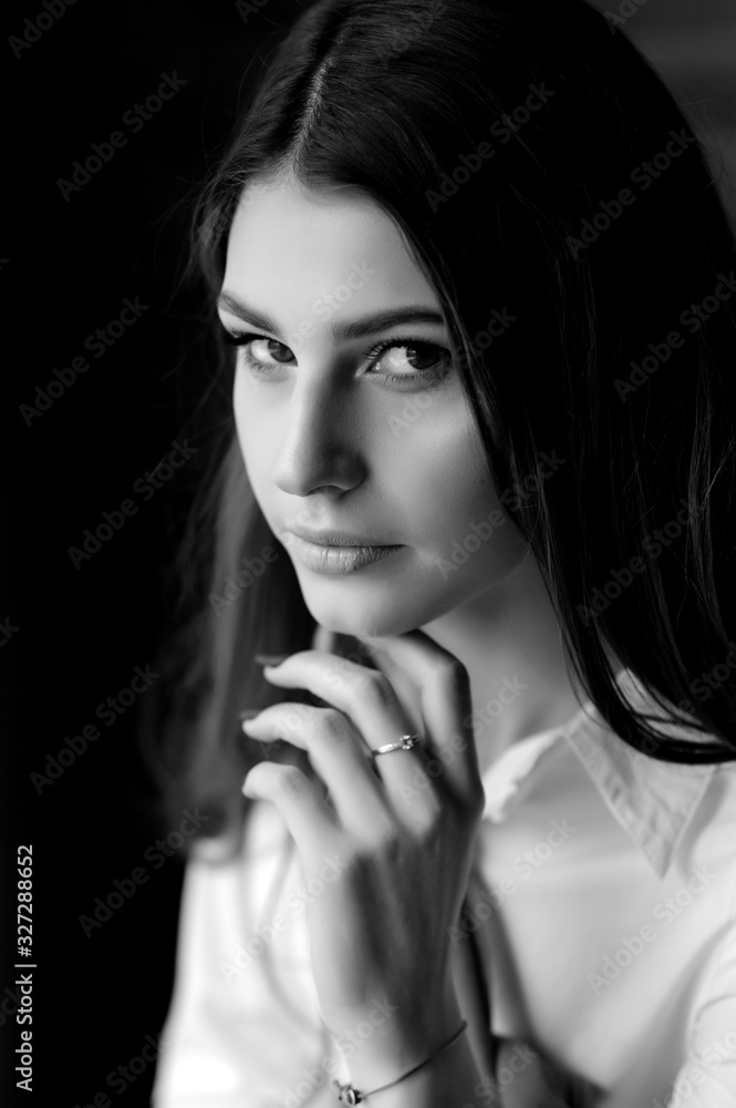 Portrait of a beautiful brunette girl in a white shirt Portrait of a beautiful brunette girl in a white shirt
