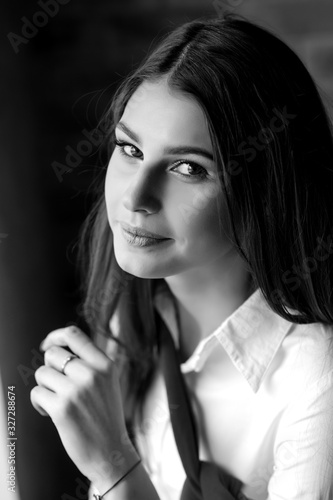 Portrait of a beautiful brunette girl in a white shirt © Mykola