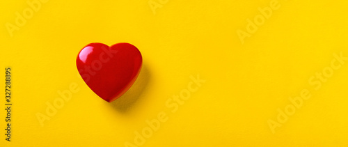 red heart on a yellow background, symbol of love, panoramic mock-up with space for text