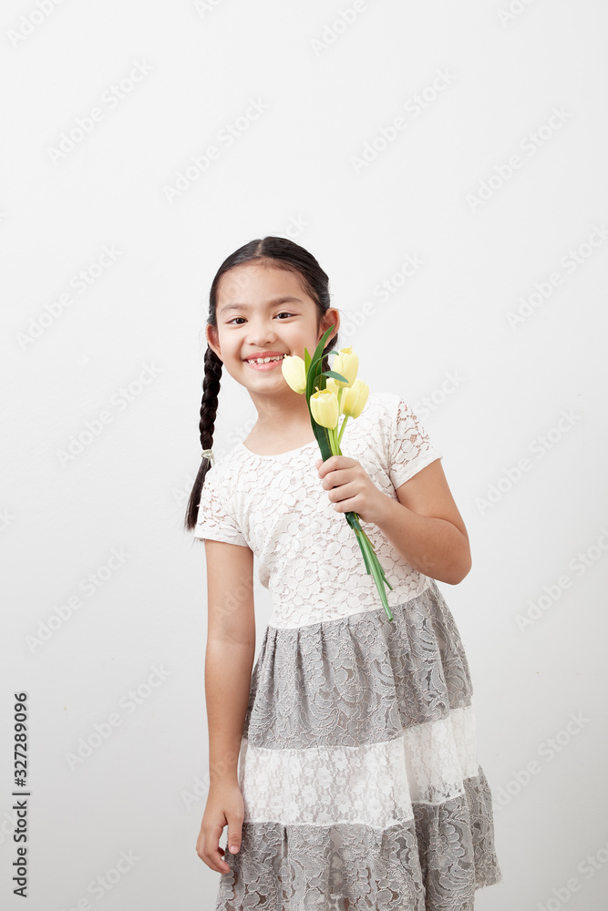 little girl holding yellow tulips on white little girl holding yellow tulips on white