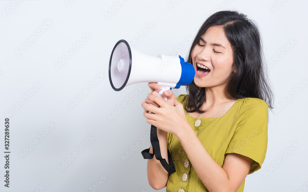 young woman standing smile holding and shouting into megaphone young woman standing smile holding and shouting into megaphone