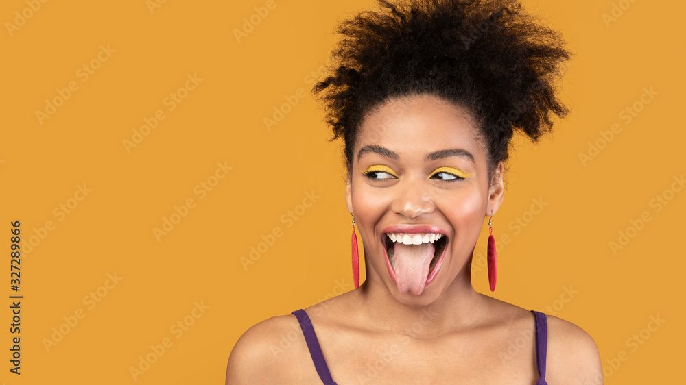 Happy black woman sticking out tongue and having fun Stock Photo ...