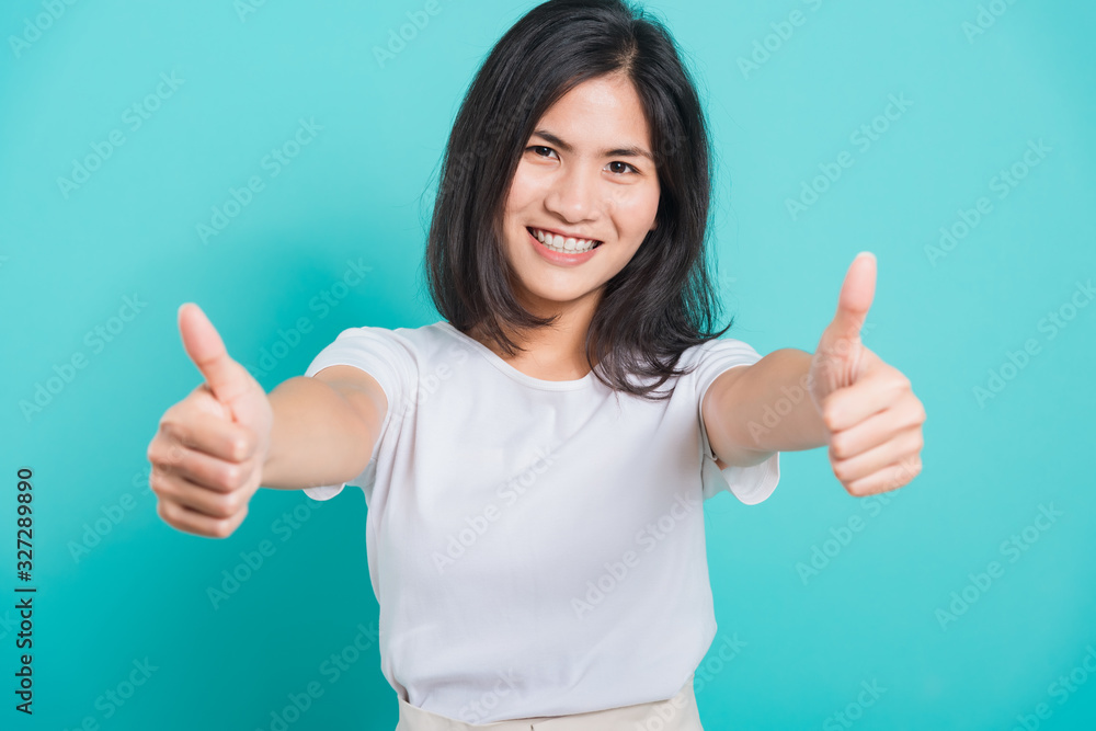 Portrait Asian beautiful young woman standing, She made finger thumbs up Portrait Asian beautiful young woman standing, She made finger thumbs up