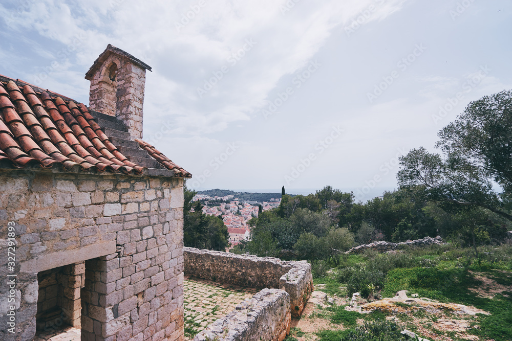 Ancient small catholic chapel made from stones with tiled roof. Ancient small catholic chapel made from stones with tiled roof.
