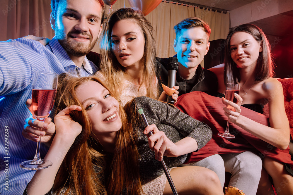 happy cheerful adults, women and men spending day-off in karaoke bar, young ladies and guys wearing party clothes, dresses. energetic and emotional group of people have fun happy cheerful adults, women and men spending day-off in karaoke bar, young ladies and guys wearing party clothes, dresses. energetic and emotional group of people have fun