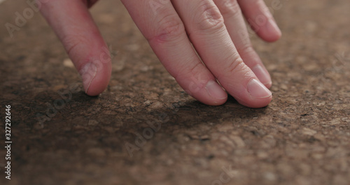 man hands touch dark cork surface © GCapture
