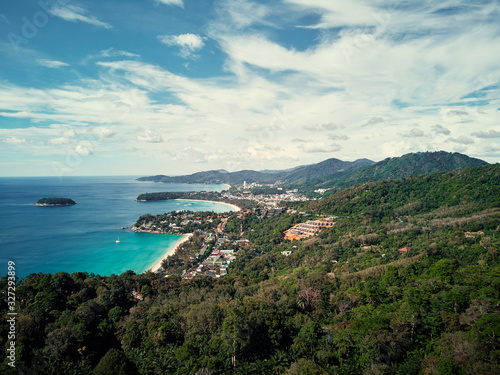 Kata and Karon beach view point. Beautiful landscape with ocean shore, green hills, cloudy sky. Phuket, Thailand.