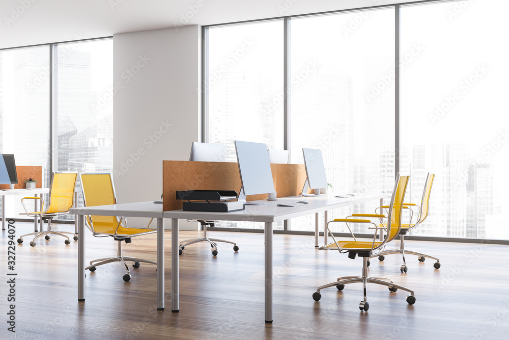 White open space office with yellow chairs