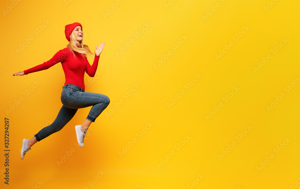 Girl runs fast. concept of energy and vitality.yellow background - obrazy, fototapety, plakaty 