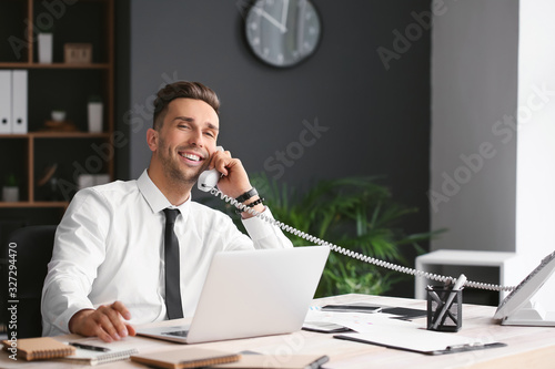 Happy businessman talking b...