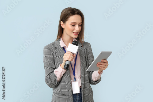 Female journalist on color background photo