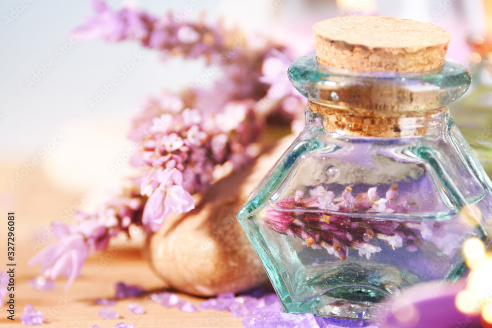 lavender oil in a glass bottle on a background of fresh flowers. Aromatherapy. lavender oil in a glass bottle on a background of fresh flowers. Aromatherapy.