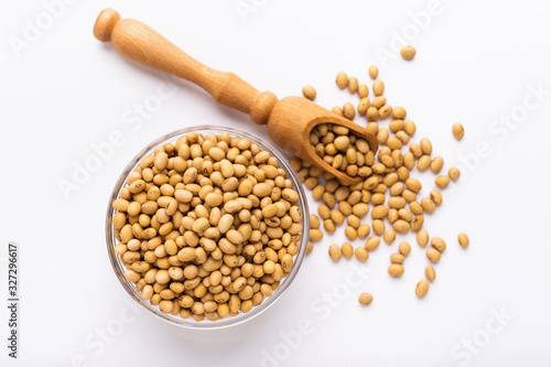 Soya beans in glass bowl and wooden spoon