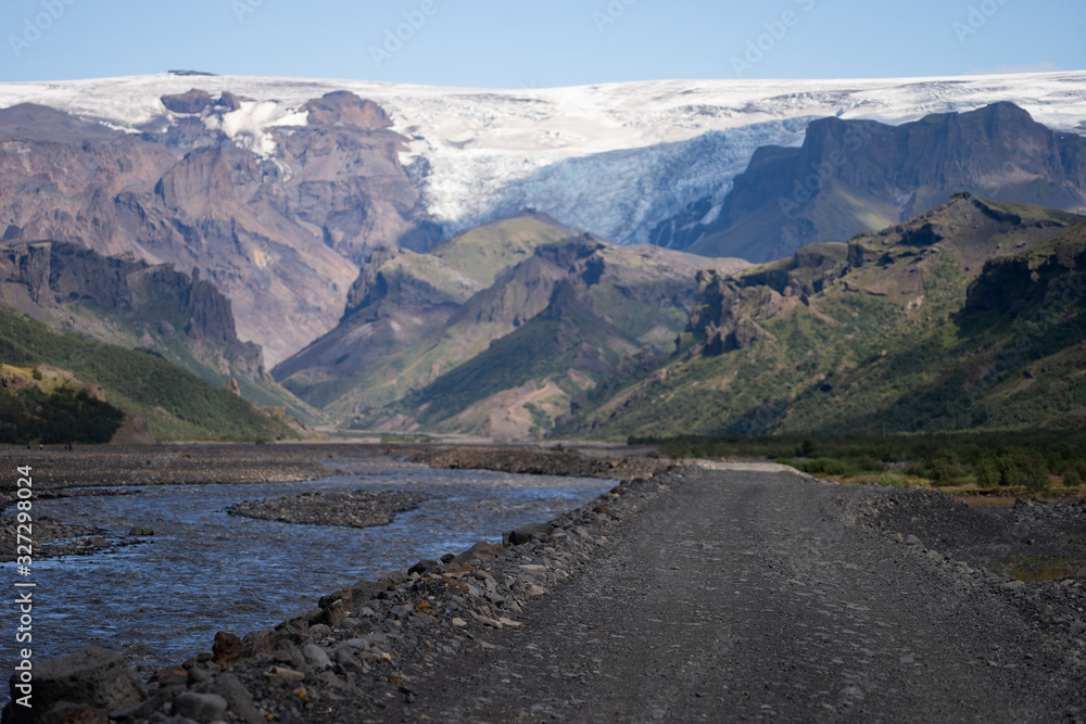 Scenic view Of Mountain Road Among Snowy Mountains nearby river in Thorsmork, Iceland