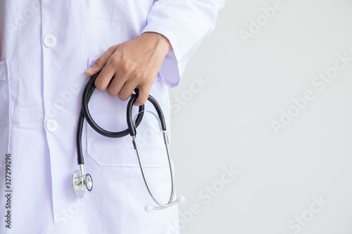 doctor or nurse standing holding stethoscope and red heart.Concept: Consult Doctor cardiologist in the hospital, Female in her Medical Office with Stethoscope, clinic healthcare professionalism