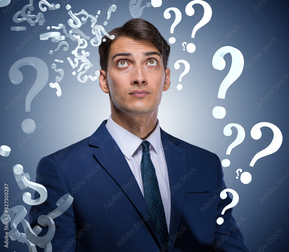 Businessman in uncertainty concept with many unanswered question