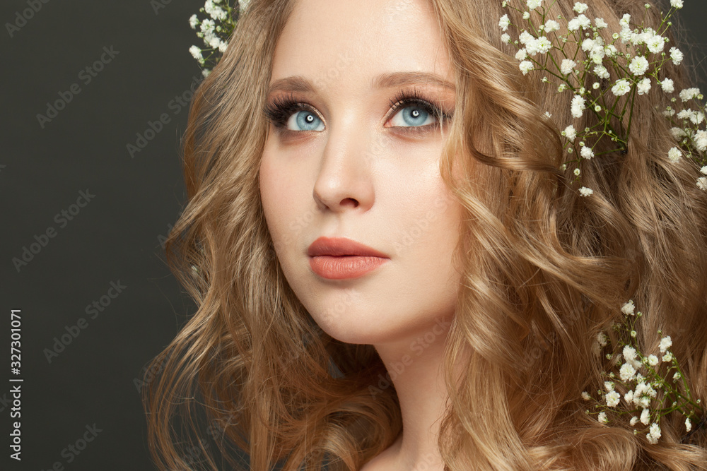 Fototapeta premium Portrait of perfect blonde woman with wedding hairdo on dark background