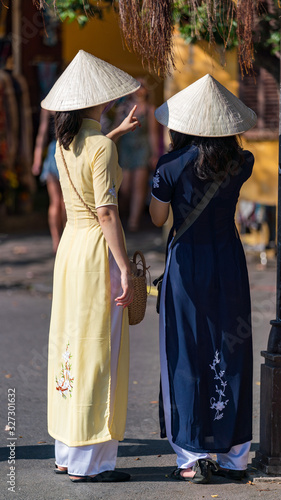 Vietnamese young women wearing "Ao Dai", Vietnamese national garment. © hit1912