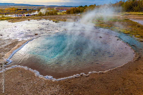 Geysir Golden Circle in Iceland deep blue water in geothermal pool steaming hot salty crust Blesi
