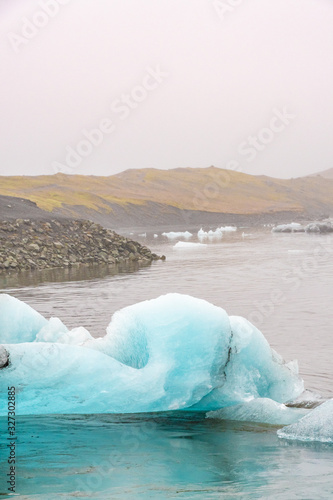 Joekulsarlon Glacier Lagoon ice floes in front of lake shore line photo